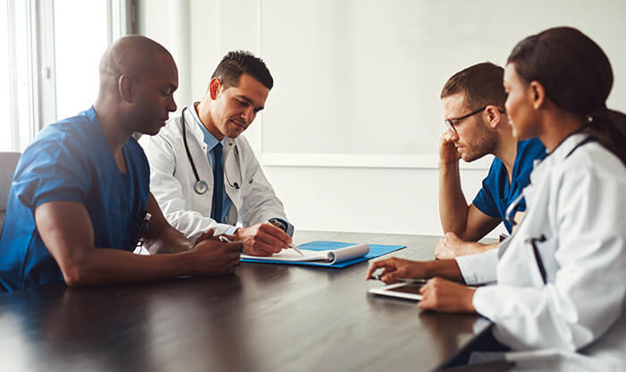 4 American Heart Association doctors discussing job candidates.