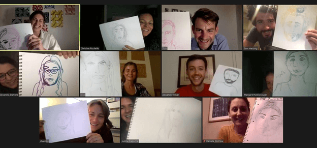 A Zoom meeting with participants holding up self-portraits.