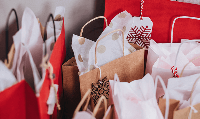Gifts in brightly colored holiday bags