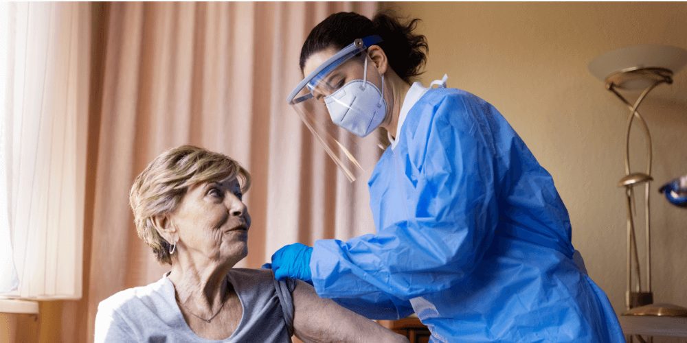 Nurse administers shot to patient