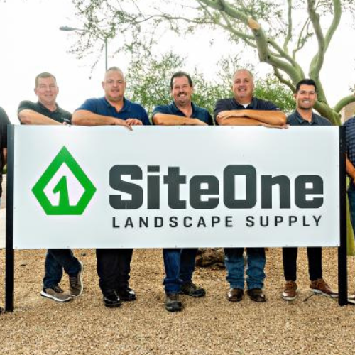 SiteOne team poses outside by their office sign